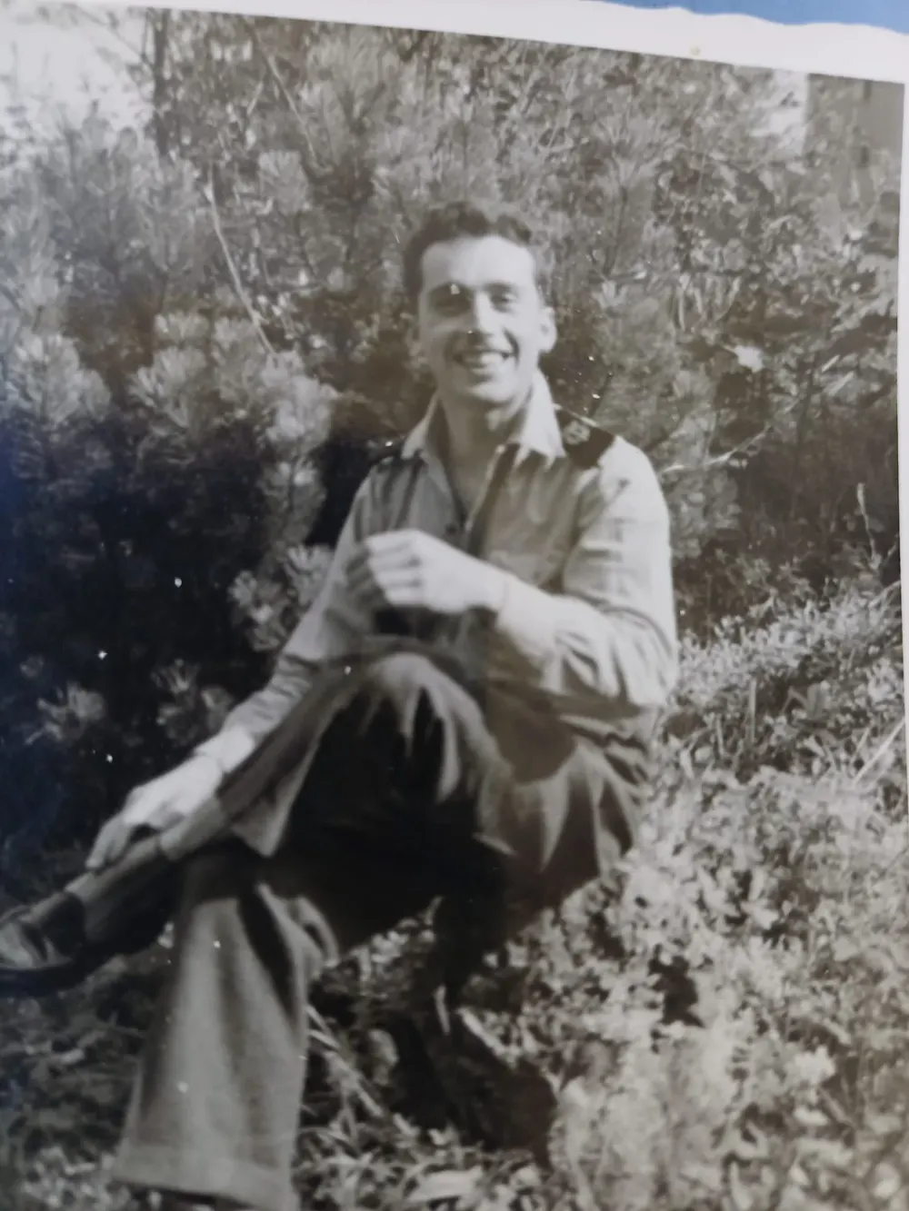 Bernard photographed in France in 1954, sitting outdoors in shirtsleeves