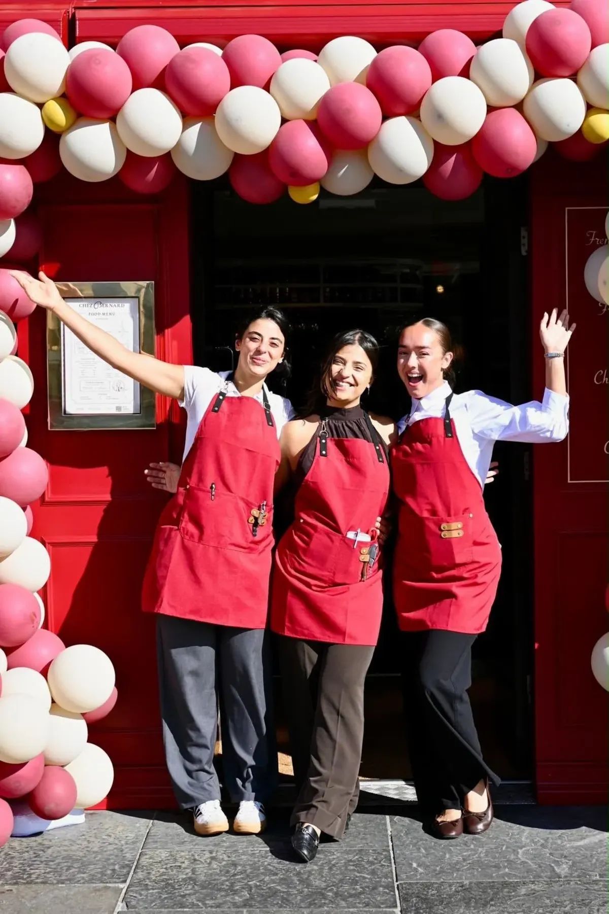 The Chez Bernard team outside the red front door with balloons